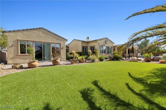 7504 Frittata Ave, Las Vegas, NV 89113 - rear view of house with stucco siding, a yard, and a patio area