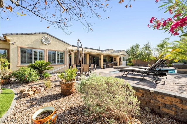 7504 Frittata Ave, Las Vegas, NV 89113 - rear view of house featuring a patio, an outdoor pool, stucco siding, and a hot tub