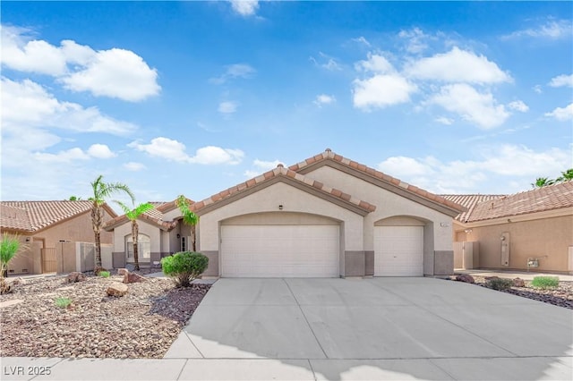 5437 Escallonia St, Las Vegas, NV 89149 - mediterranean / spanish-style house featuring an attached garage, stucco siding, and driveway