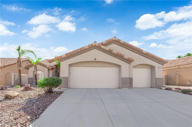 5437 Escallonia St, Las Vegas, NV 89149 - mediterranean / spanish-style home with driveway, a garage, stucco siding, and a tiled roof