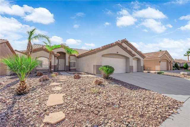 5437 Escallonia St, Las Vegas, NV 89149 - mediterranean / spanish home featuring stucco siding, concrete driveway, a tiled roof, and a garage