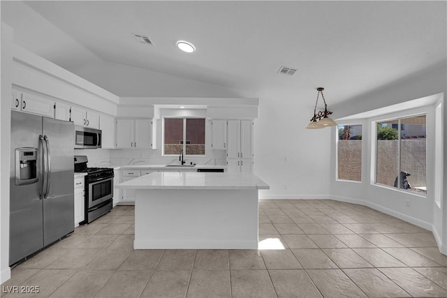 5437 Escallonia St, Las Vegas, NV 89149 - kitchen featuring stainless steel appliances, a sink, plenty of natural light, white cabinets, and lofted ceiling