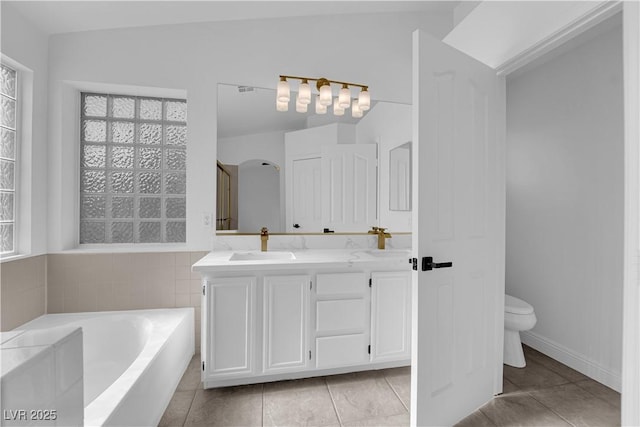 5437 Escallonia St, Las Vegas, NV 89149 - full bath with toilet, double vanity, a bath, tile patterned flooring, and lofted ceiling