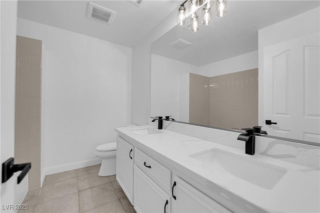 5437 Escallonia St, Las Vegas, NV 89149 - full bath with double vanity, toilet, tile patterned floors, baseboards, and a shower