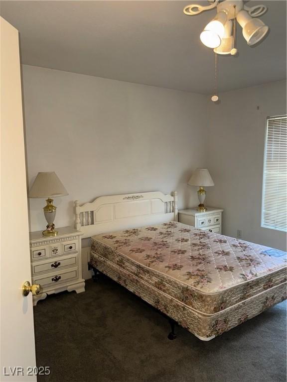 4555 E Sahara Ave Unit 122, Las Vegas, NV 89104 - bedroom featuring dark carpet and a ceiling fan