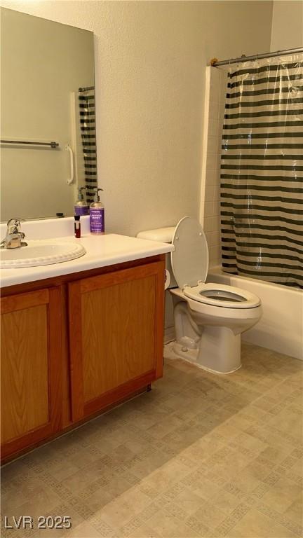 4555 E Sahara Ave Unit 122, Las Vegas, NV 89104 - bathroom with vanity, toilet, shower / tub combo with curtain, and tile patterned floors