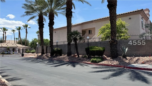 4555 E Sahara Ave Unit 122, Las Vegas, NV 89104 - view of side of property featuring stucco siding and a gate