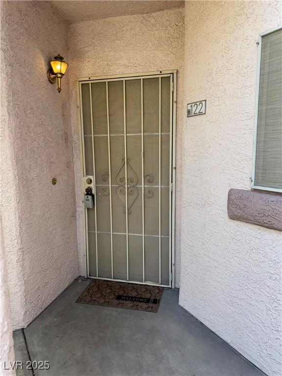 4555 E Sahara Ave Unit 122, Las Vegas, NV 89104 - doorway to property featuring stucco siding