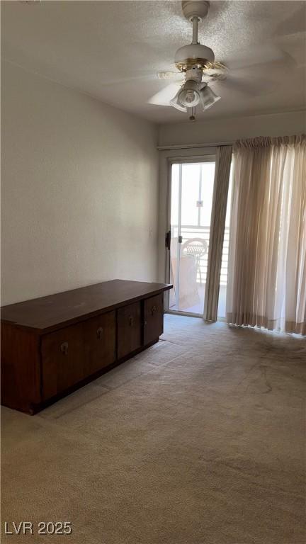 4555 E Sahara Ave Unit 122, Las Vegas, NV 89104 - unfurnished room featuring light carpet and a ceiling fan