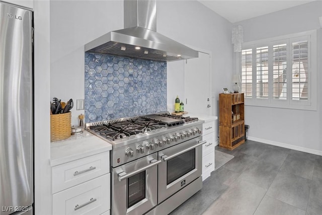 6173 Sabine Ranch Rd, Las Vegas, NV 89131 - kitchen featuring stainless steel appliances, wall chimney exhaust hood, backsplash, light countertops, and white cabinetry