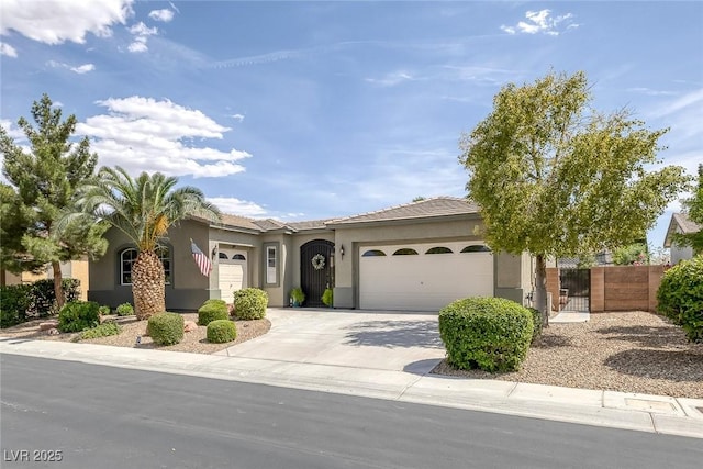 6173 Sabine Ranch Rd, Las Vegas, NV 89131 - view of front of property featuring a garage, stucco siding, driveway, and a gate