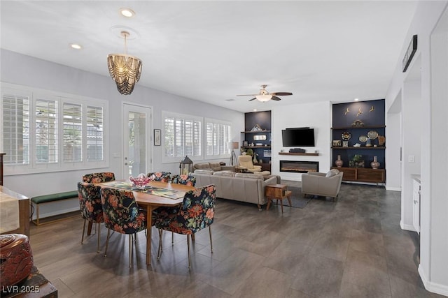 6173 Sabine Ranch Rd, Las Vegas, NV 89131 - dining room with ceiling fan, built in shelves, and baseboards