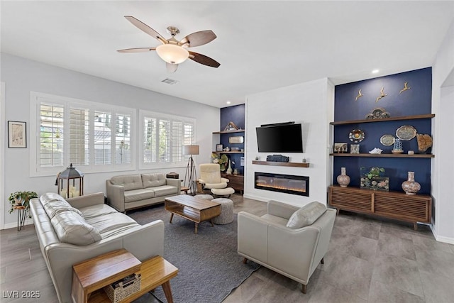 6173 Sabine Ranch Rd, Las Vegas, NV 89131 - living room with ceiling fan, a glass covered fireplace, baseboards, and recessed lighting