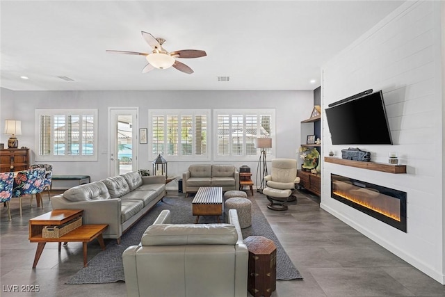 6173 Sabine Ranch Rd, Las Vegas, NV 89131 - living area with a large fireplace, ceiling fan, and recessed lighting