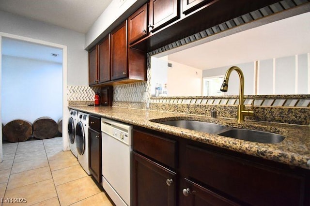 634 Oakmont Ave Unit 1903, Las Vegas, NV 89109 - kitchen with white dishwasher, a sink, washing machine and clothes dryer, backsplash, and light tile patterned floors