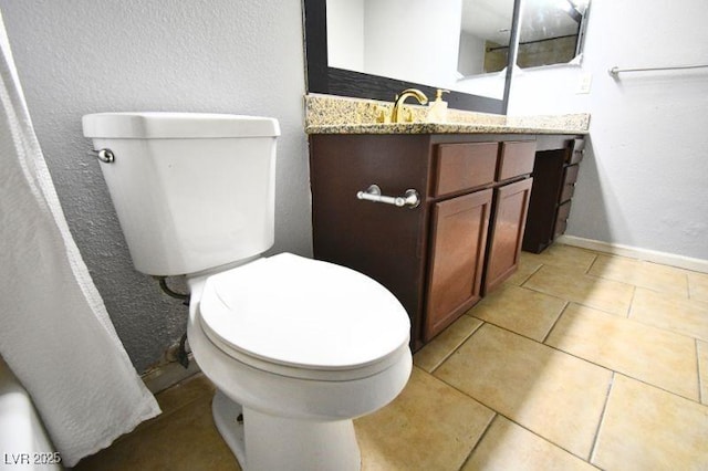 634 Oakmont Ave Unit 1903, Las Vegas, NV 89109 - bathroom with toilet, vanity, baseboards, and tile patterned flooring