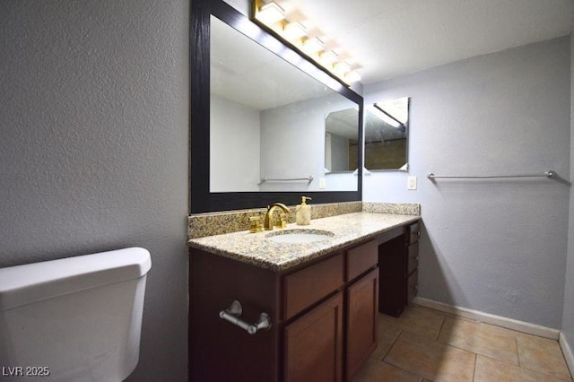 634 Oakmont Ave Unit 1903, Las Vegas, NV 89109 - bathroom with vanity, toilet, tile patterned flooring, baseboards, and a textured wall