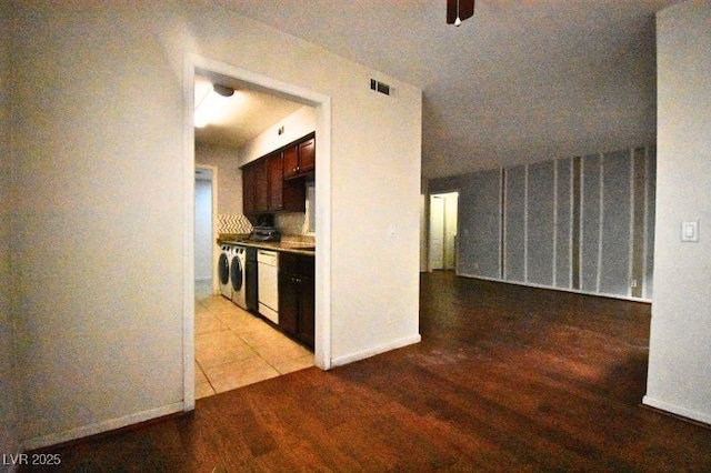 634 Oakmont Ave Unit 1903, Las Vegas, NV 89109 - kitchen featuring dishwasher, dark brown cabinetry, and washer / clothes dryer