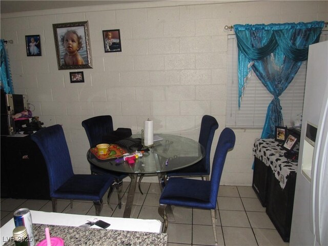 2409 Maroney Ave, Las Vegas, NV 89104 - dining room with light tile patterned floors and concrete block wall
