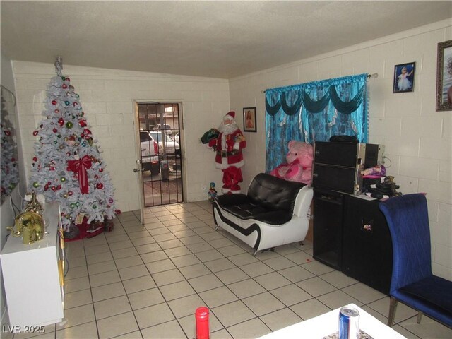 2409 Maroney Ave, Las Vegas, NV 89104 - living room featuring concrete block wall and light tile patterned floors