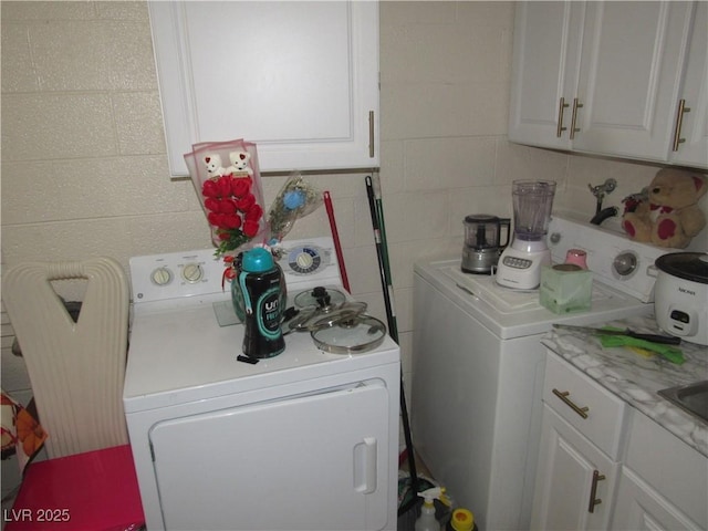 2409 Maroney Ave, Las Vegas, NV 89104 - laundry area with washer / dryer and tile walls