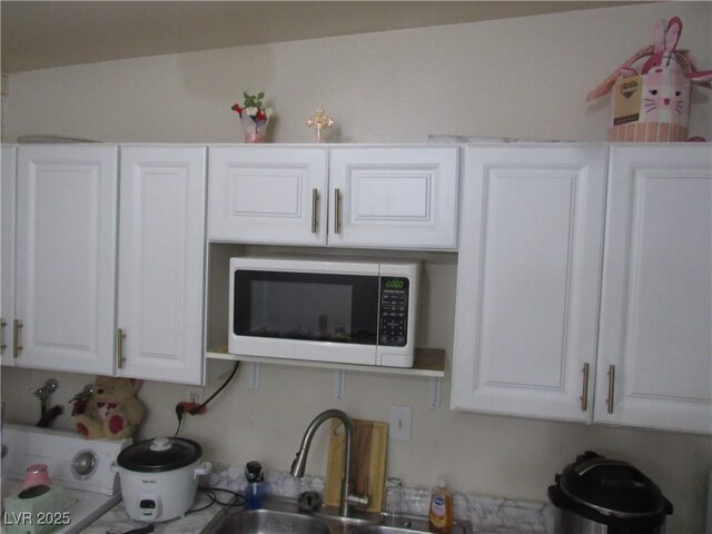 2409 Maroney Ave, Las Vegas, NV 89104 - kitchen featuring white cabinetry and a sink