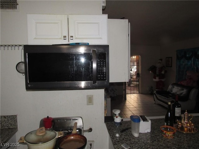2409 Maroney Ave, Las Vegas, NV 89104 - kitchen view of stainless steel microwave, white cabinetry, and dark countertops