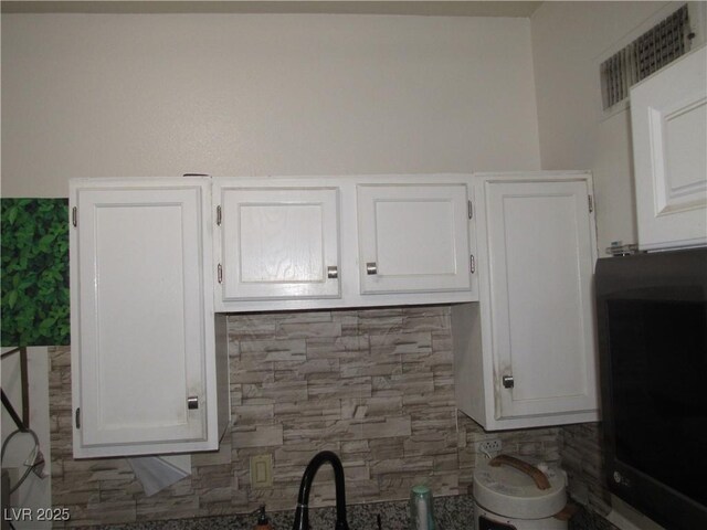 2409 Maroney Ave, Las Vegas, NV 89104 - kitchen with white cabinets and backsplash
