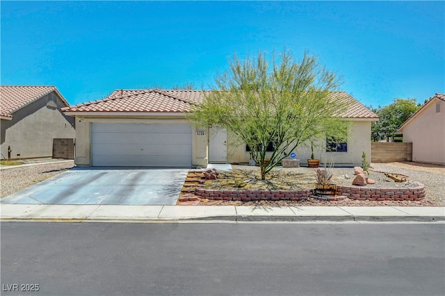 5236 Krista Alethea St, North Las Vegas, NV 89031 - view of front of home featuring stucco siding, a tile roof, a garage, and concrete driveway