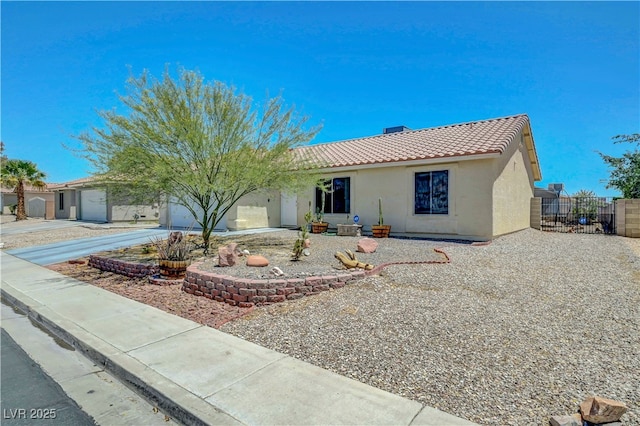 5236 Krista Alethea St, North Las Vegas, NV 89031 - view of front of property featuring a tiled roof, stucco siding, and driveway