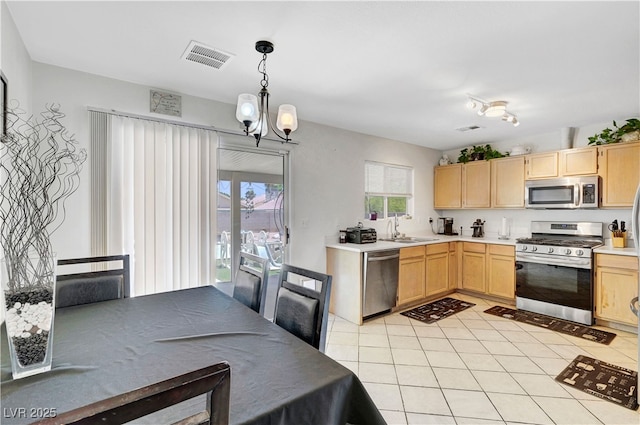 5236 Krista Alethea St, North Las Vegas, NV 89031 - kitchen featuring appliances with stainless steel finishes, light brown cabinets, a sink, a chandelier, and light countertops