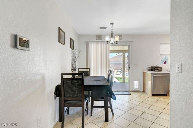 5236 Krista Alethea St, North Las Vegas, NV 89031 - dining area featuring a textured wall, a chandelier, and light tile patterned floors