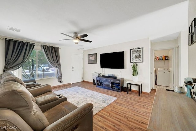 5236 Krista Alethea St, North Las Vegas, NV 89031 - living room with a ceiling fan, wood finished floors, washer and clothes dryer, and baseboards