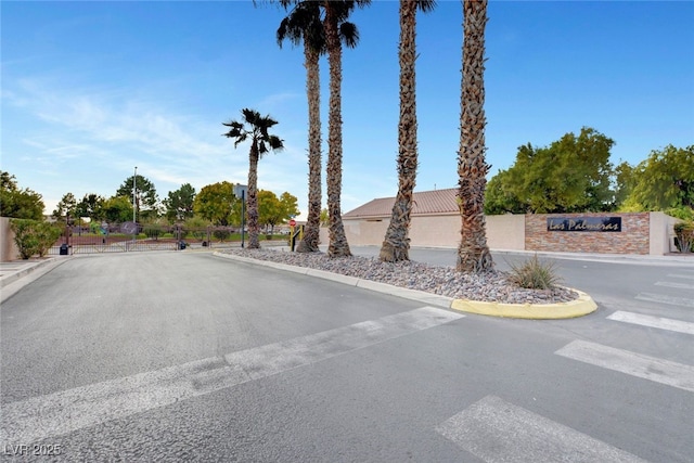 5236 Krista Alethea St, North Las Vegas, NV 89031 - view of asphalt road with a gated entry and curbs