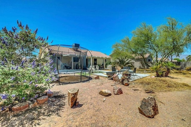 5236 Krista Alethea St, North Las Vegas, NV 89031 - rear view of house with a trampoline and a patio area