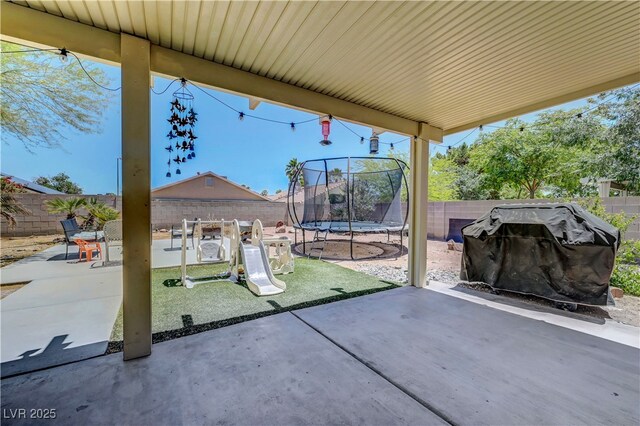 5236 Krista Alethea St, North Las Vegas, NV 89031 - fenced backyard featuring a trampoline and a patio