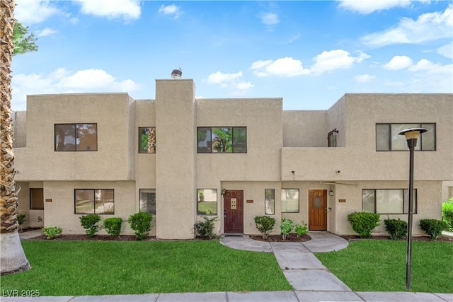 2661 Ruthe Duarte Ave, Las Vegas, NV 89121 - view of front of home with stucco siding and a front yard