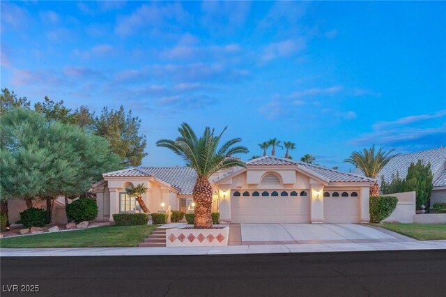 1913 Madagascar Ln, Las Vegas, NV 89117 - mediterranean / spanish home featuring stucco siding, an attached garage, driveway, and a tiled roof
