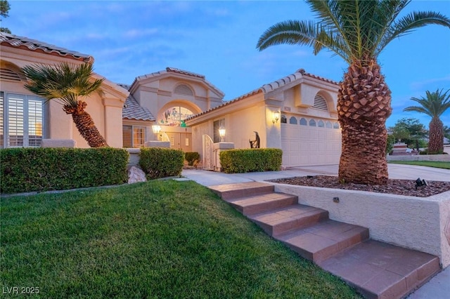 1913 Madagascar Ln, Las Vegas, NV 89117 - mediterranean / spanish house with stucco siding, a garage, a tiled roof, driveway, and a front lawn