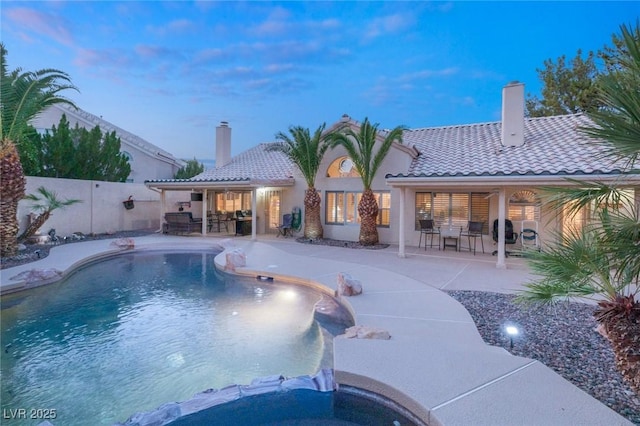 1913 Madagascar Ln, Las Vegas, NV 89117 - pool at dusk with an in-ground hot tub, a patio, a fenced backyard, and outdoor dining space