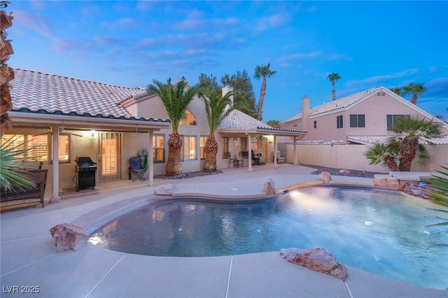 1913 Madagascar Ln, Las Vegas, NV 89117 - pool at dusk with a patio, a fenced backyard, and area for grilling