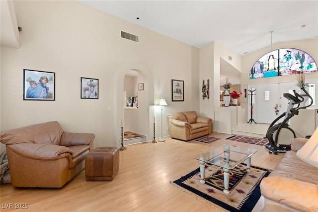 1913 Madagascar Ln, Las Vegas, NV 89117 - living room featuring arched walkways, high vaulted ceiling, and wood finished floors