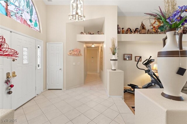 1913 Madagascar Ln, Las Vegas, NV 89117 - entrance foyer featuring light tile patterned floors, a chandelier, baseboards, and a high ceiling