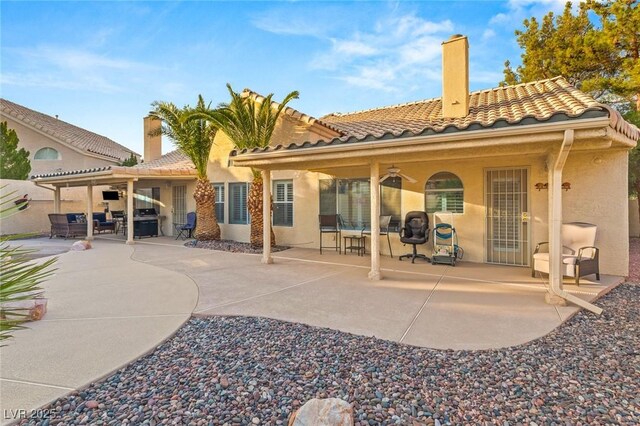 1913 Madagascar Ln, Las Vegas, NV 89117 - back of house with a patio area, a tiled roof, stucco siding, and a ceiling fan