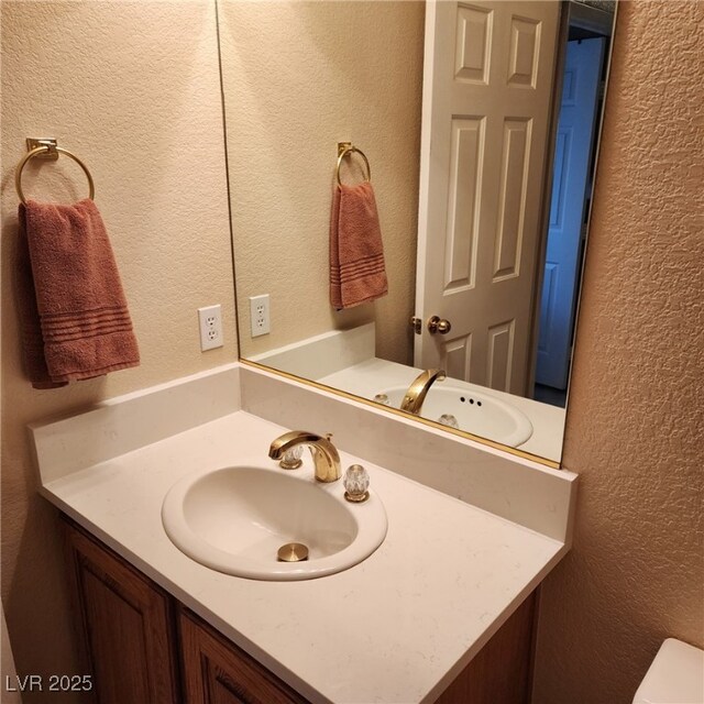 1913 Madagascar Ln, Las Vegas, NV 89117 - half bath featuring a textured wall, vanity, and toilet
