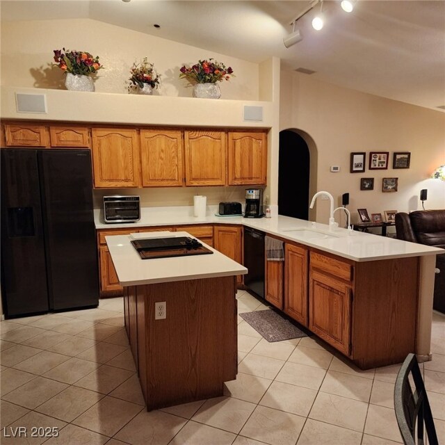 1913 Madagascar Ln, Las Vegas, NV 89117 - kitchen featuring black appliances, lofted ceiling, a sink, track lighting, and a peninsula
