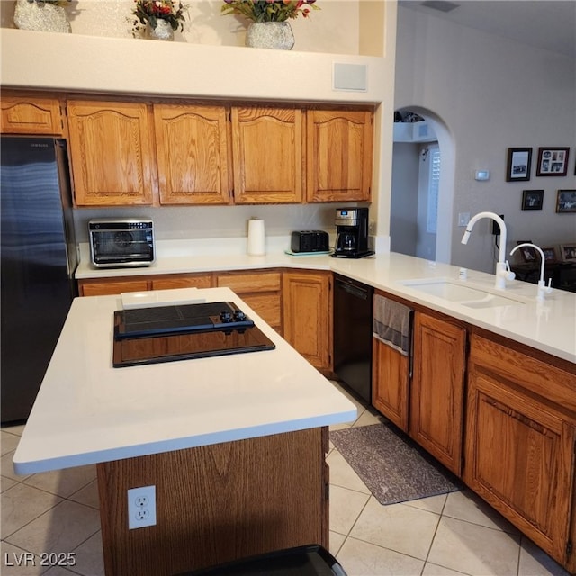 1913 Madagascar Ln, Las Vegas, NV 89117 - kitchen with black appliances, a sink, light tile patterned floors, and light countertops