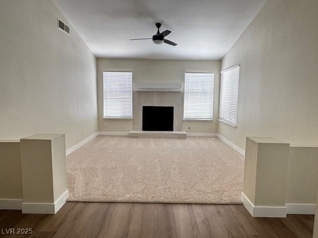 8010 Coffee Tree Ct, Las Vegas, NV 89123 - unfurnished living room with ceiling fan, baseboards, and a fireplace with raised hearth
