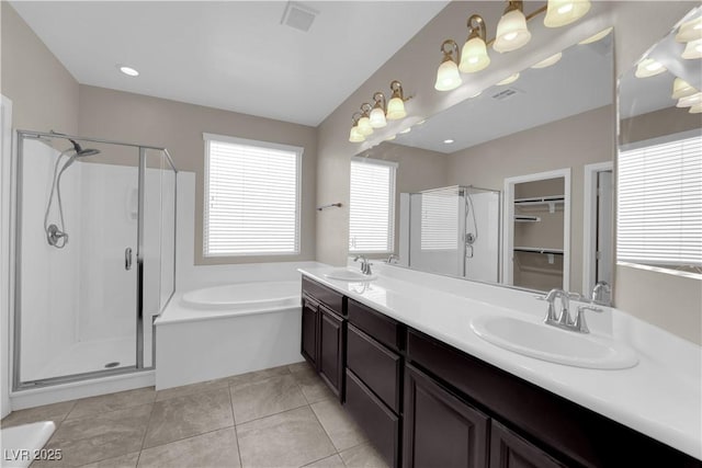 7300 Lavender Rose Ave, Las Vegas, NV 89117 - bathroom with a shower stall, a garden tub, double vanity, and tile patterned floors