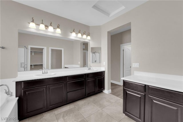 7300 Lavender Rose Ave, Las Vegas, NV 89117 - bathroom with double vanity, a garden tub, tile patterned floors, and baseboards